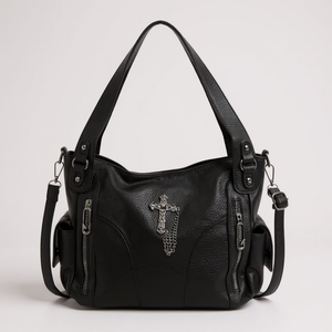 Black handbag with a decorative cross on a light gray background